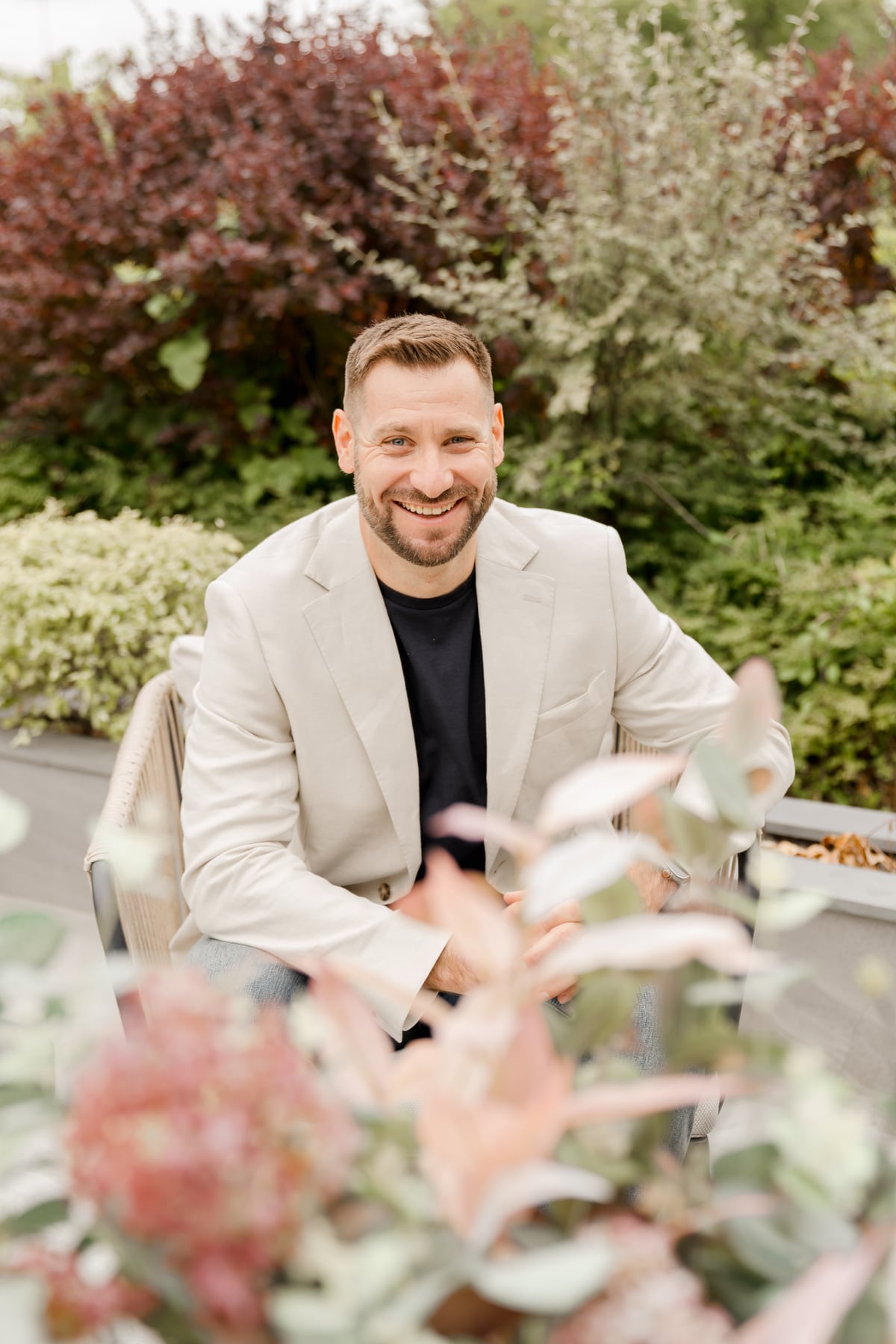 Brad Wendes smiling in a garden setting