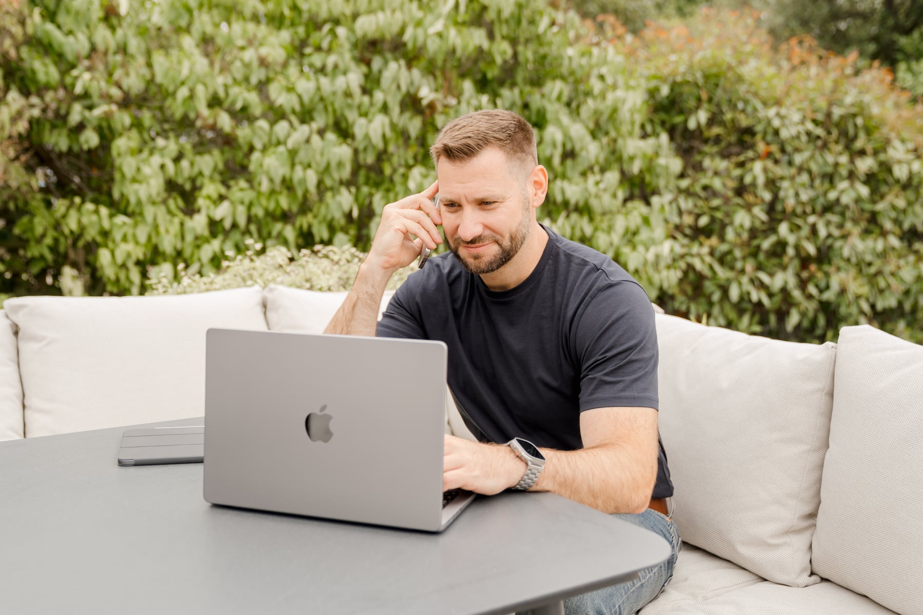 Brad Wendes working at a laptop and speaking on the phone